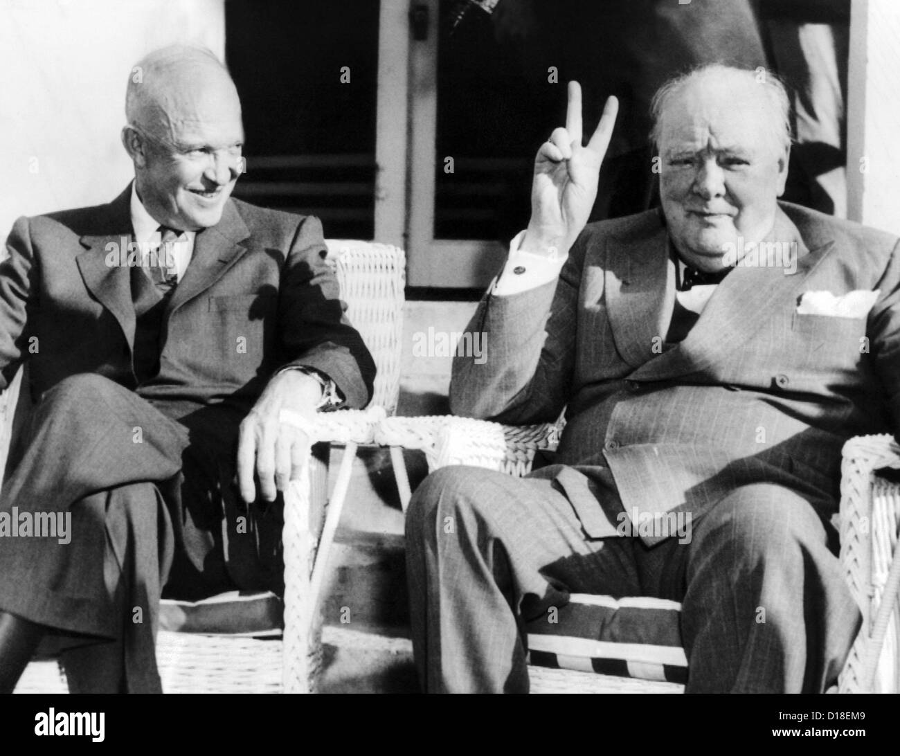 President Eisenhower watches Britain's Prime Minister Winston Churchill give his famous V-for-victory. The two were meeting Stock Photo