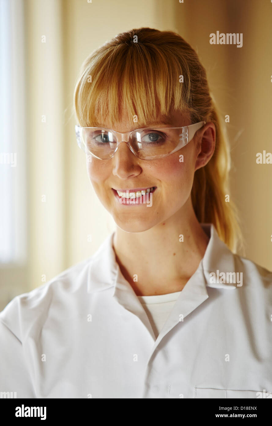 Woman wearing white coat and glasses Stock Photo - Alamy