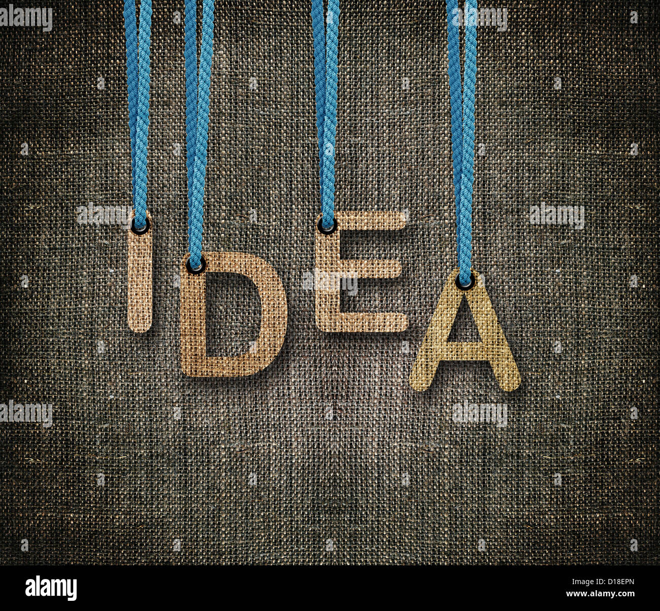 Idea word hanging by rope as puppeteer on sackcloth background. Stock Photo