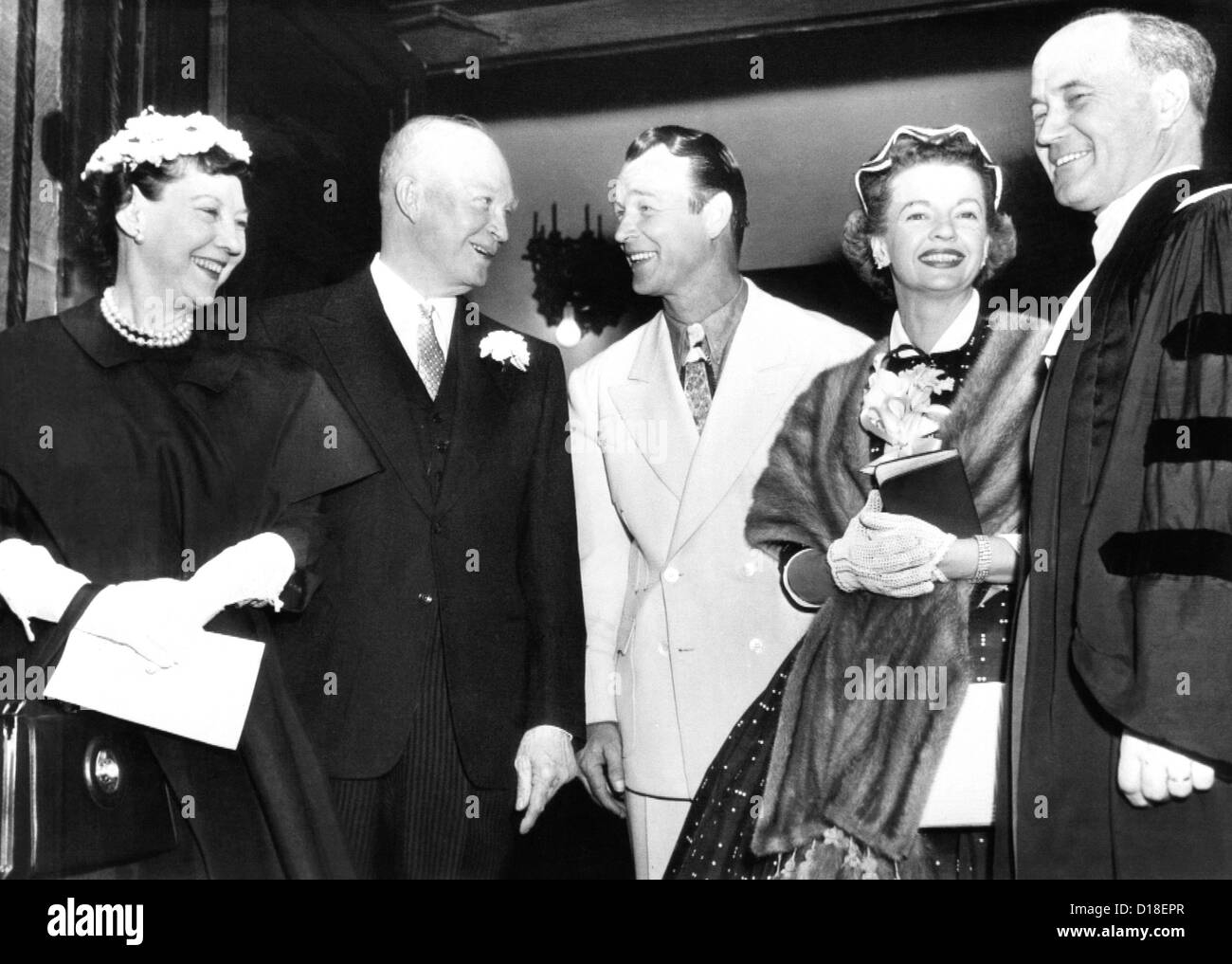 President and Mrs. Eisenhower (left) talk with cowboy film star Roy Rogers and his wife, Dale Evans. Both couples were Stock Photo