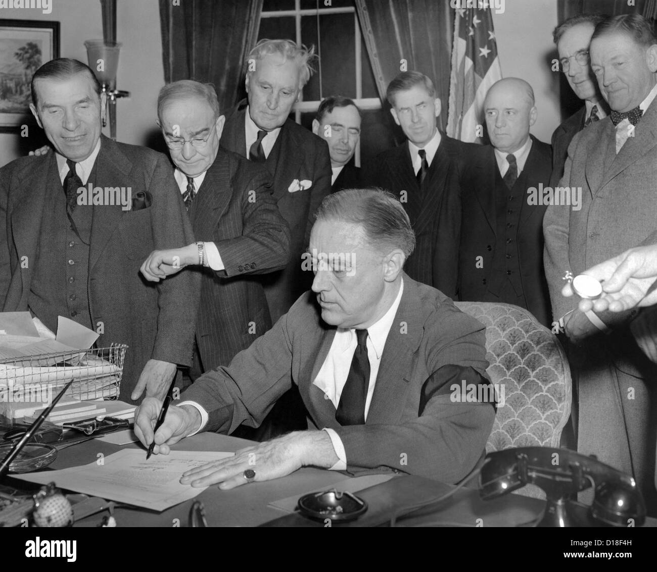 President Franklin D. Roosevelt signs the joint congressional resolution declaring war with Japan at 4:10 PM, Dec. 8, 1941. Stock Photo