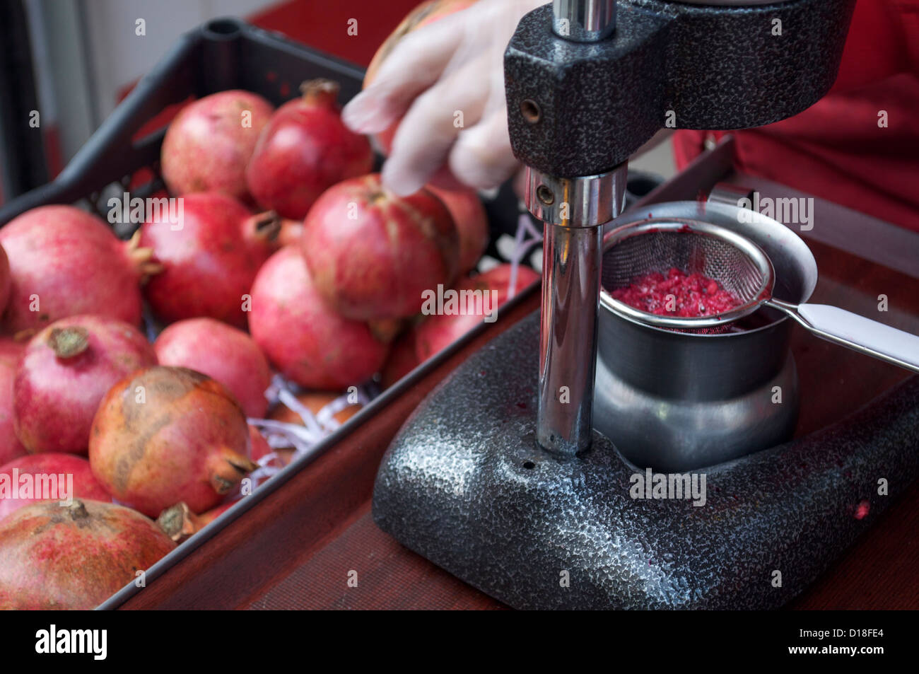 Pomegranate juice seller in Istanbul Turkey using a press Stock Photo -  Alamy