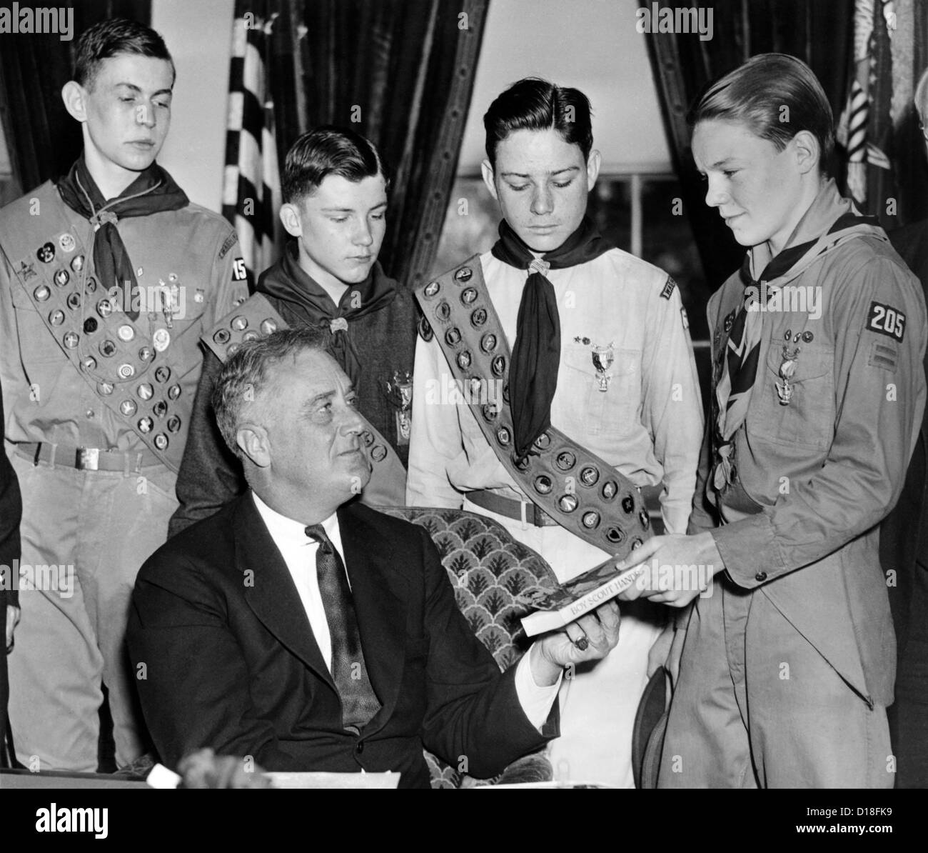 President Franklin Roosevelt receives the five-millionth copy of the Boy Scout Handbook. Eagle Scouts presented the special Stock Photo