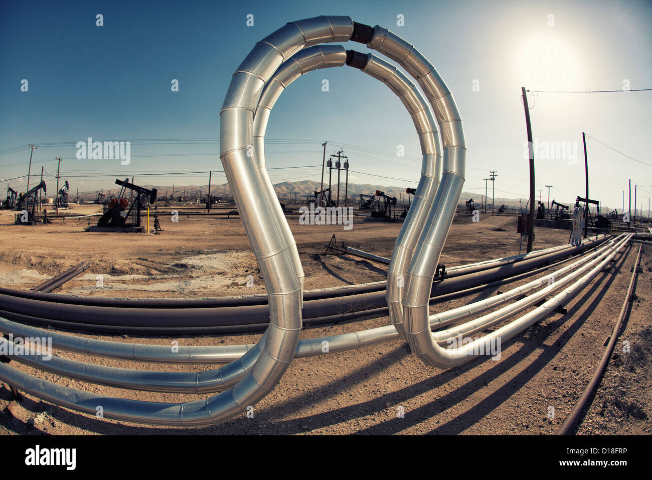 Curved pipes in oil field Stock Photo