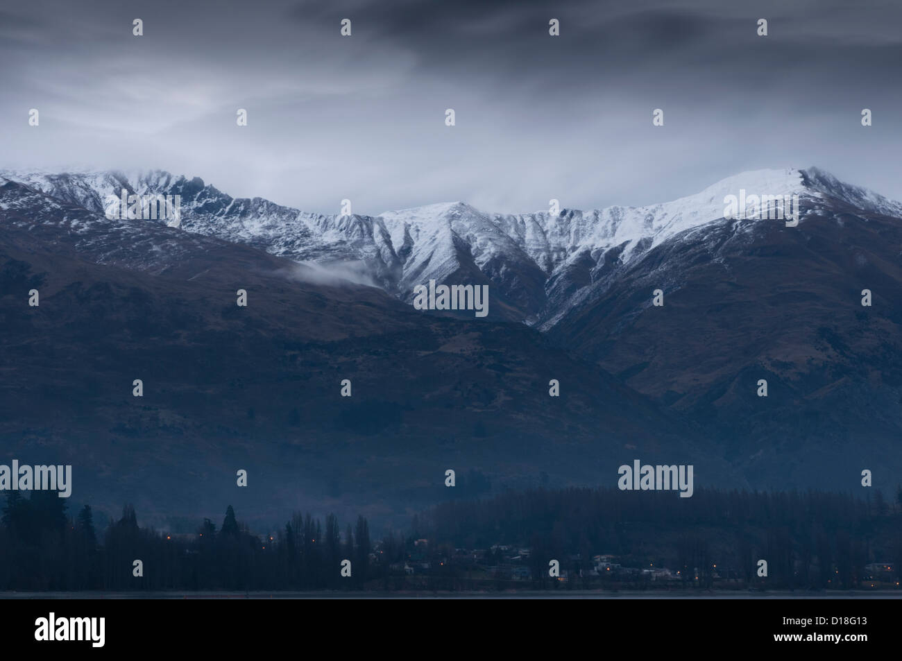 Clouds gathering over snowy mountains Stock Photo