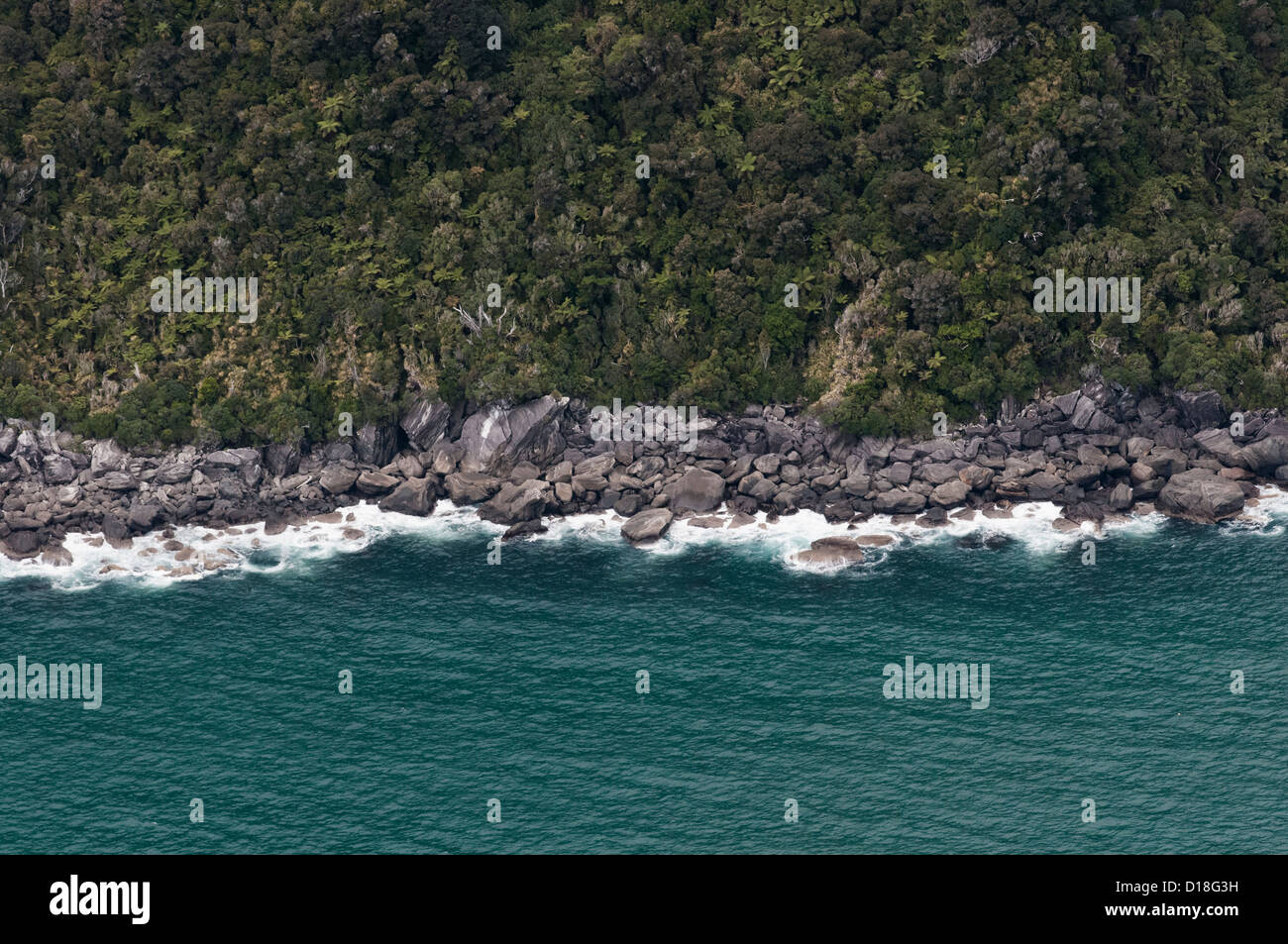 Aerial view of waves on rocky beach Stock Photo