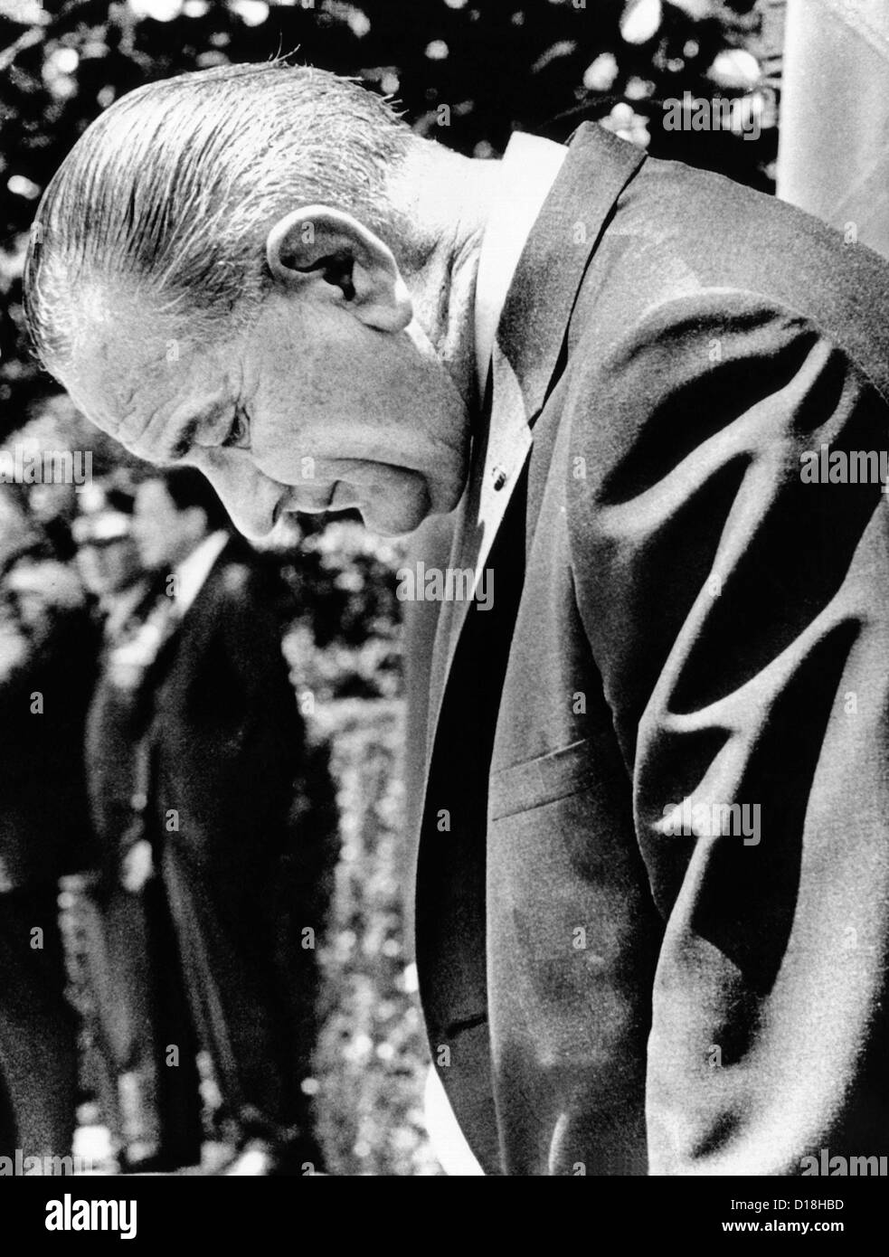 President Lyndon Johnson stands with head lowered as he awaits the arrival of President Hastings Kamuzu Banda of Malawi. Dec. Stock Photo