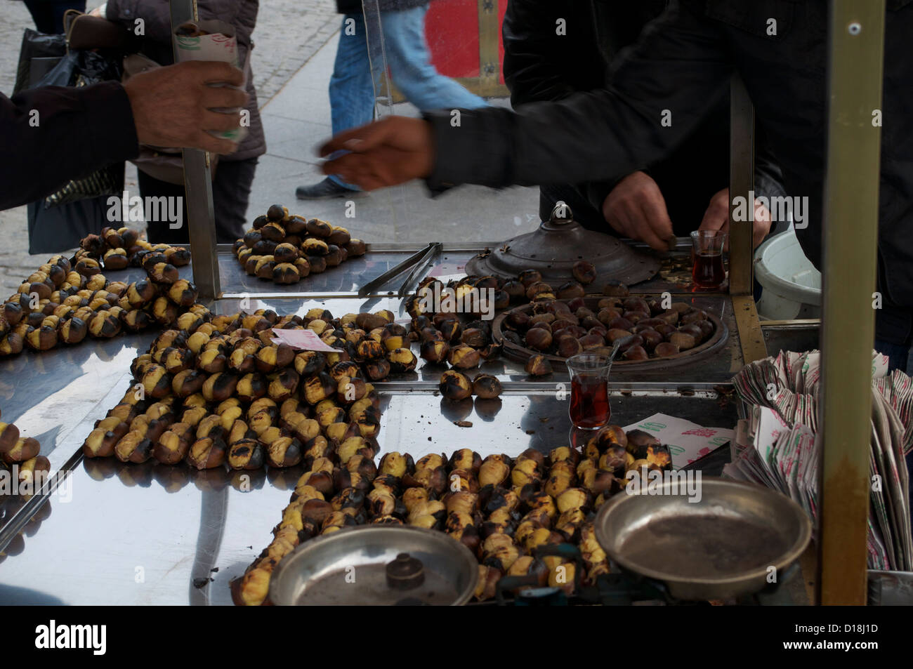 Buying roasted horse chestnuts from a vendor on the streets of Istanbul Stock Photo