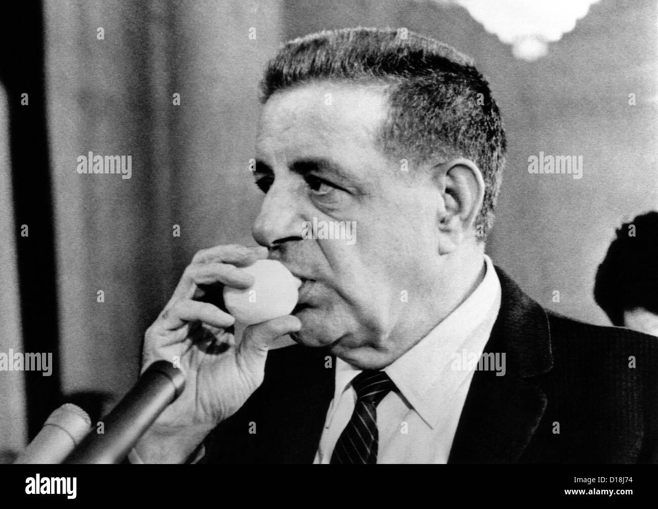 Joseph Valachi sucking a lemon juice container during Senate Investigations Subcommittee. The juice eased his hoarseness from Stock Photo