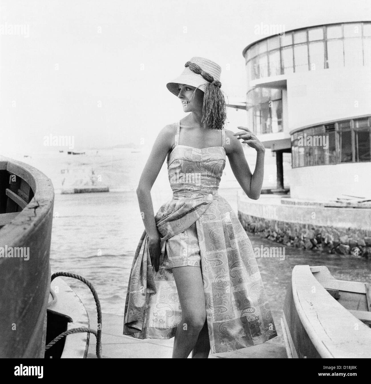 Printed beach ensemble with shorts. A cover-up skirt can take the outfit to dinner and more formal environments. 1960. Stock Photo