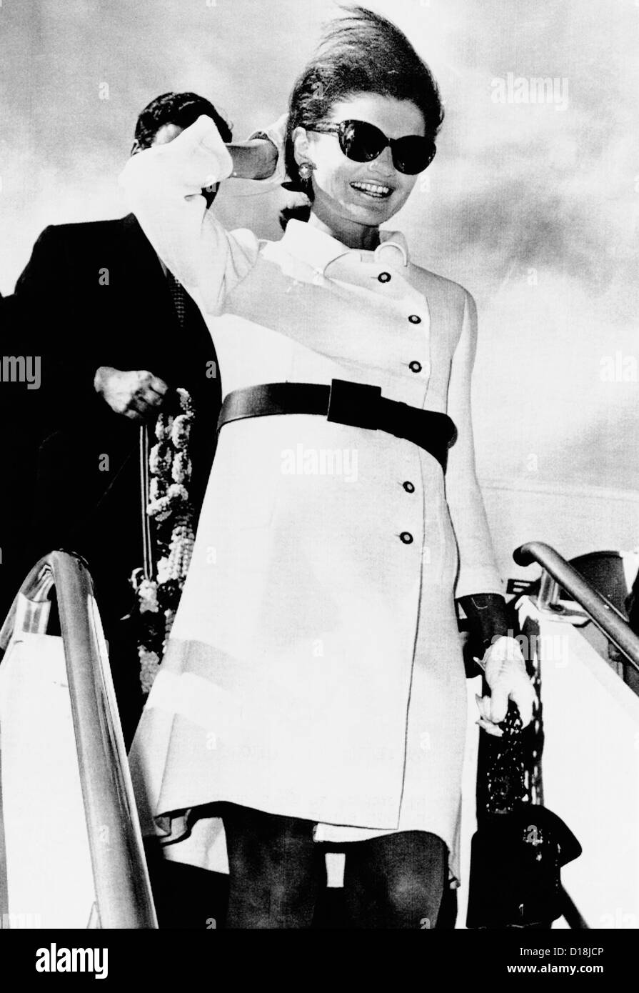 Jacqueline Kennedy, wearing a white coat dress with a short skirt. She deplanes in Rome following a 10-day Asian holiday. Nov. Stock Photo