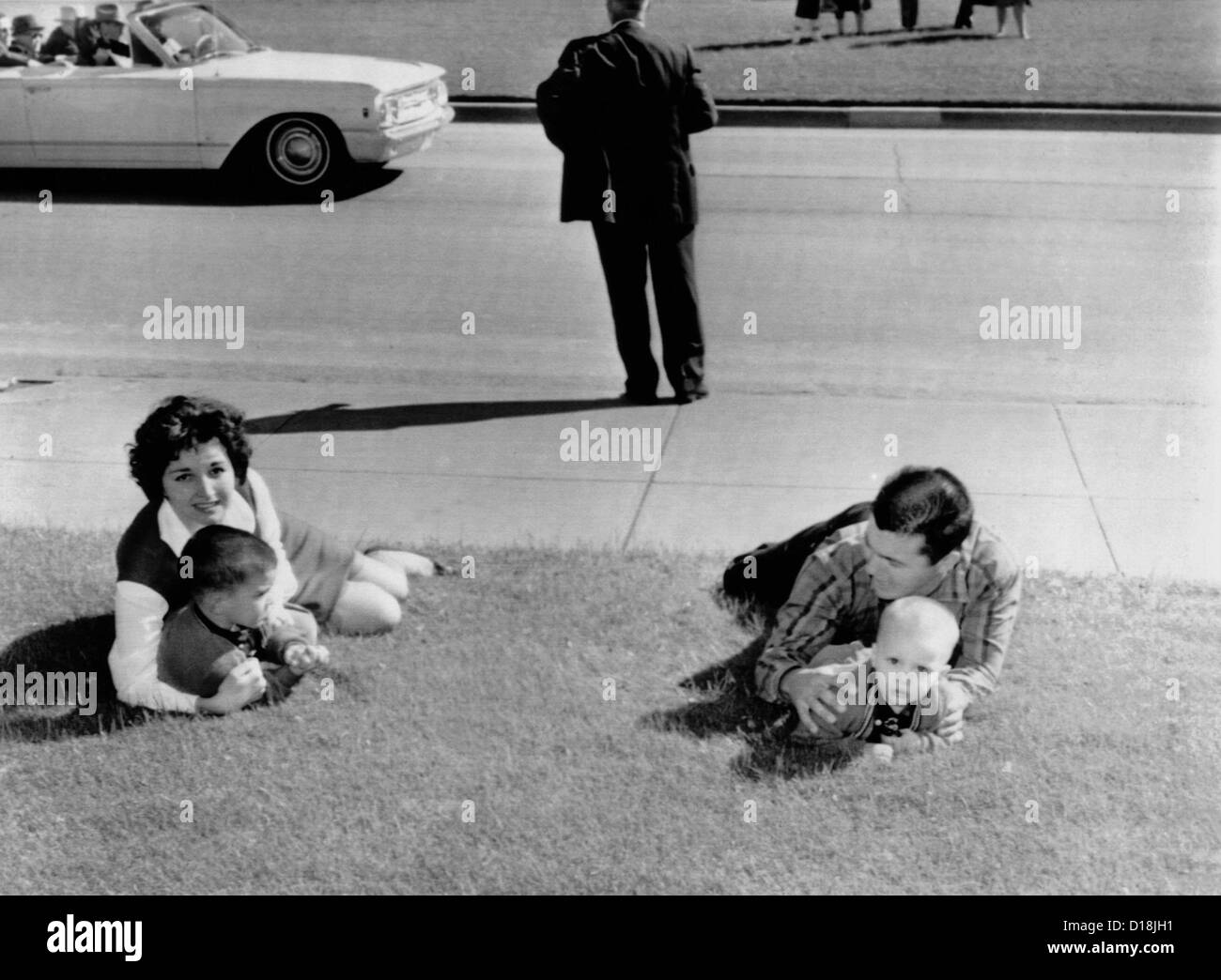 Witnesses to the Kennedy assassination. Frightened spectators drop to the ground after shots were fired at Dealy Plaza during Stock Photo