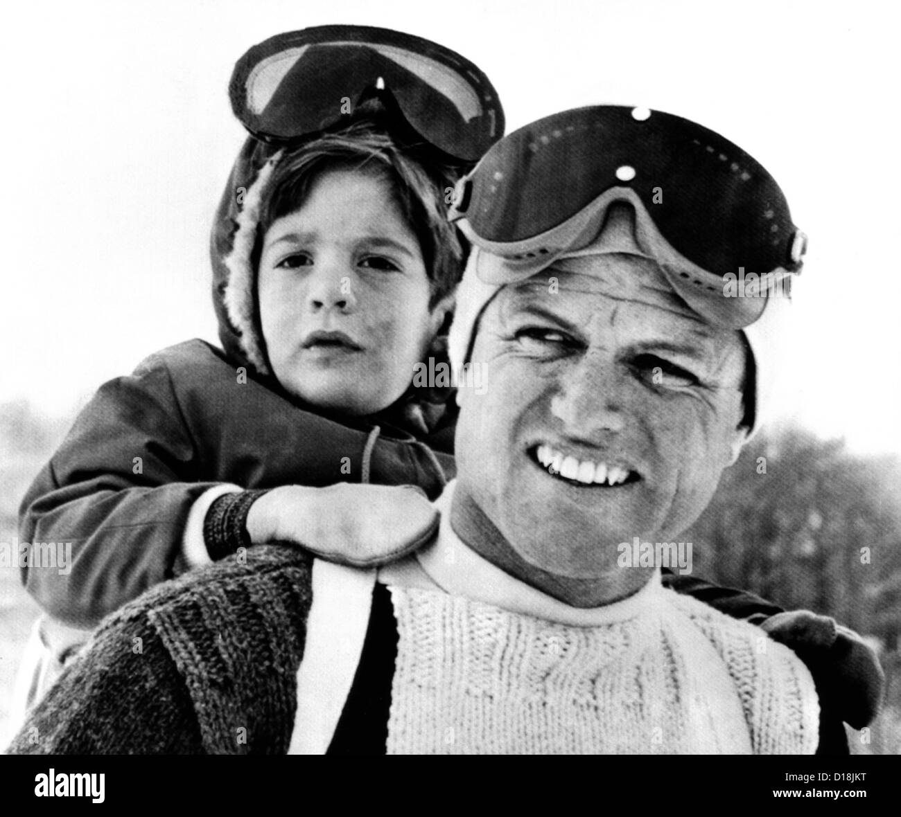 Ted Kennedy gives his nephew John F. Kennedy Jr. a piggy-back ride down the ski slopes in Stowe, Vermont. The Kennedy family Stock Photo