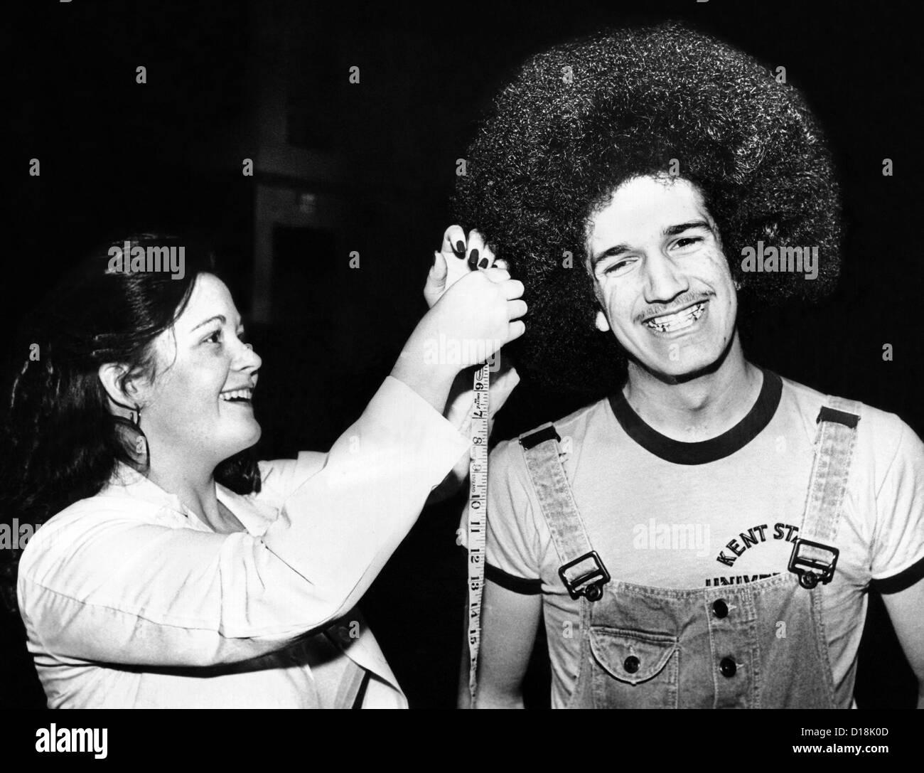 Trish Blankenburg measures the hair of David Messina, Bat Village, High School Senior. Cleveland, Ohio, Feb. 1980. Stock Photo