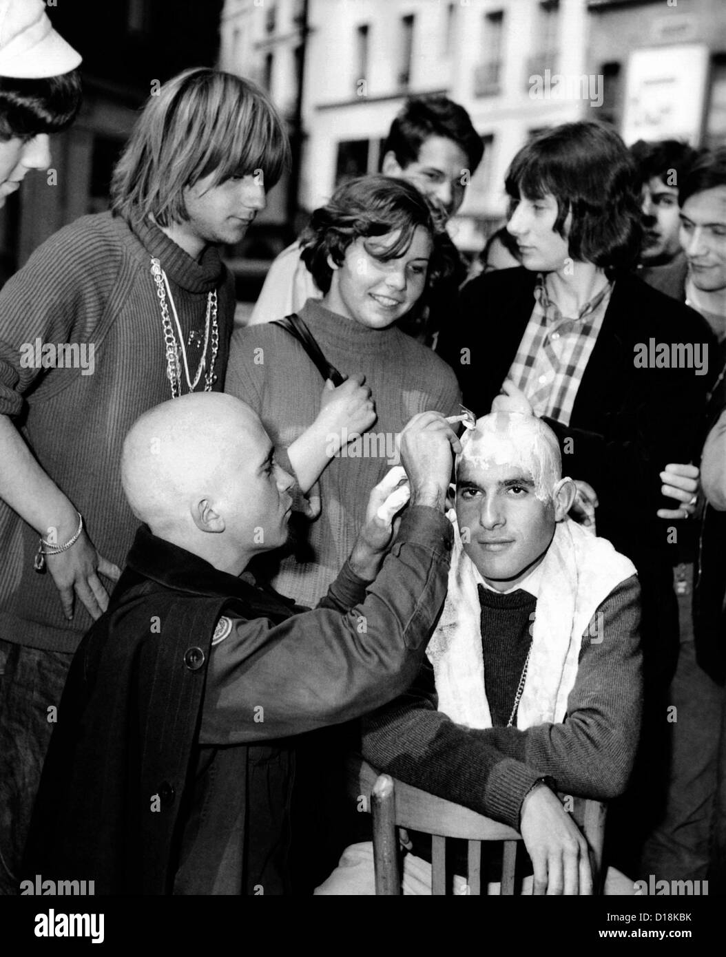 New hair fashions for the Parisian counterculture. Some 'beatniks' are trading in their long hair for shaved heads. July 30, Stock Photo