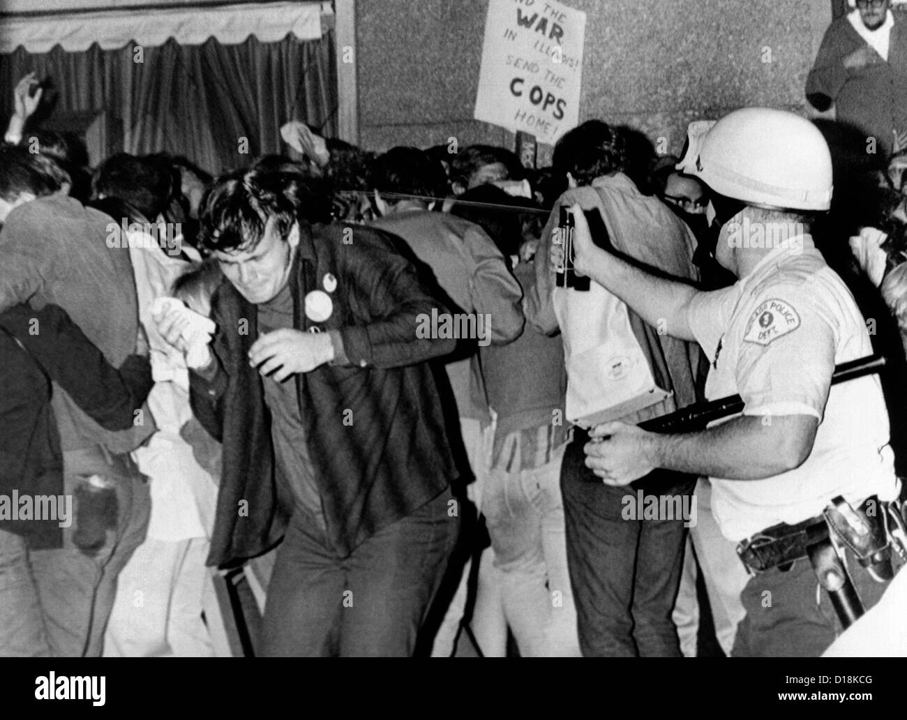 Chicago Police officer (right) uses pressure can to squirts mace at anti-Vietnam War demonstrators. The protest was outside the Stock Photo