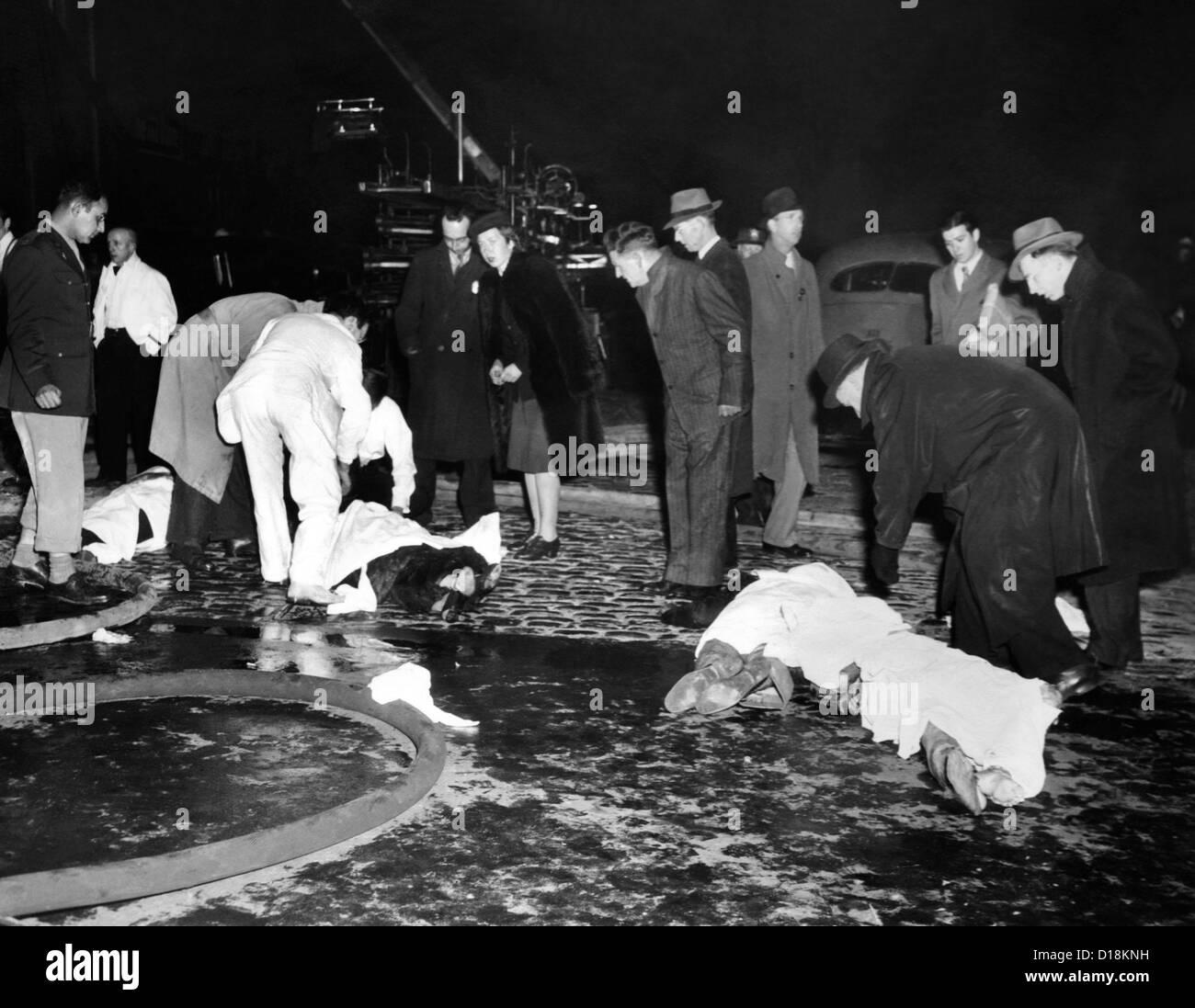 Coconut Grove Nightclub Fire. Four bodies covered with sheets in the street waiting transport to Boston's overwhelmed morgues. Stock Photo