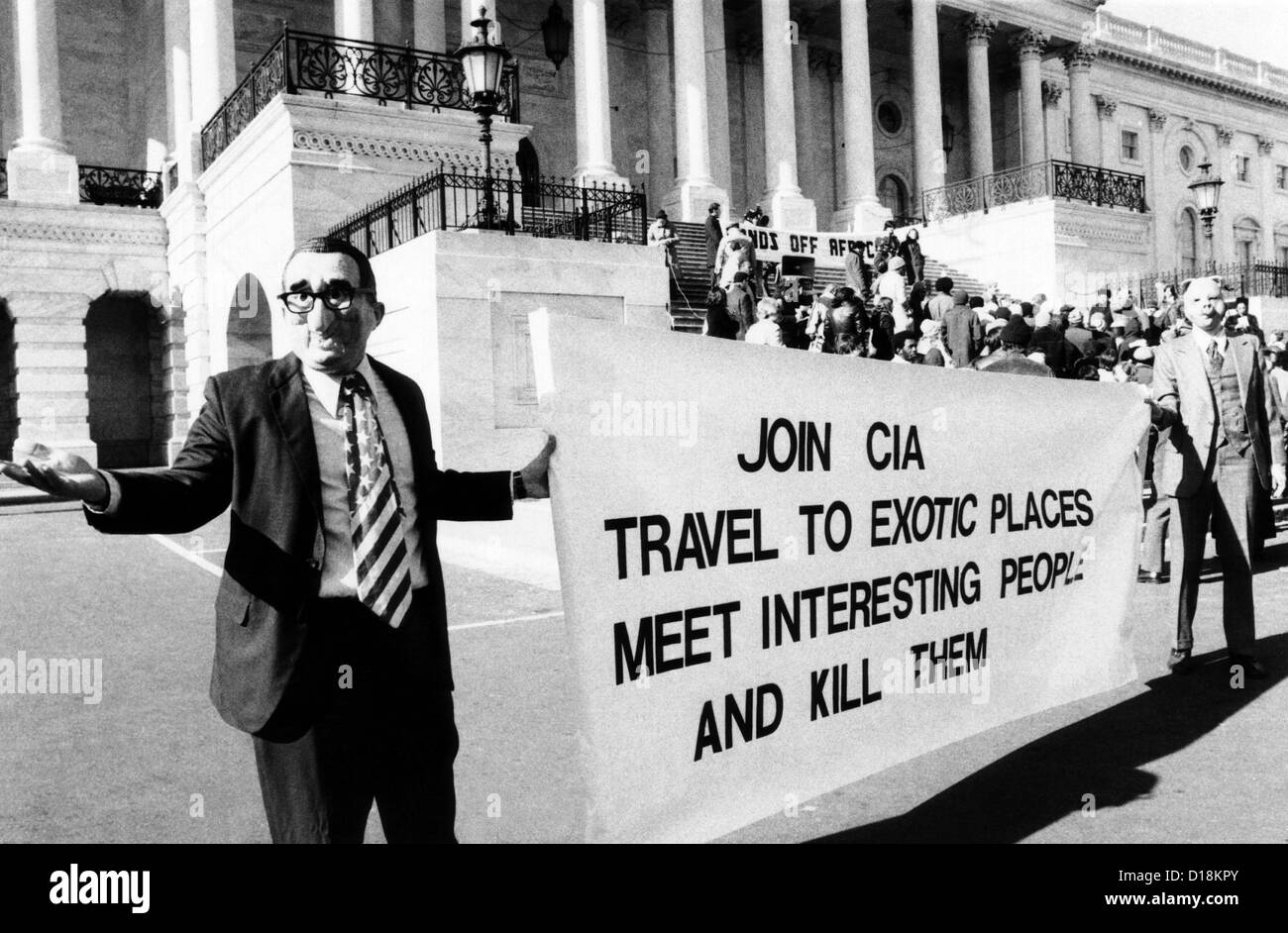 Rally protesting U.S. involvement in Angola. Demonstrators in front of the Capitol wear masks of Henry Kissinger and a pig. Stock Photo