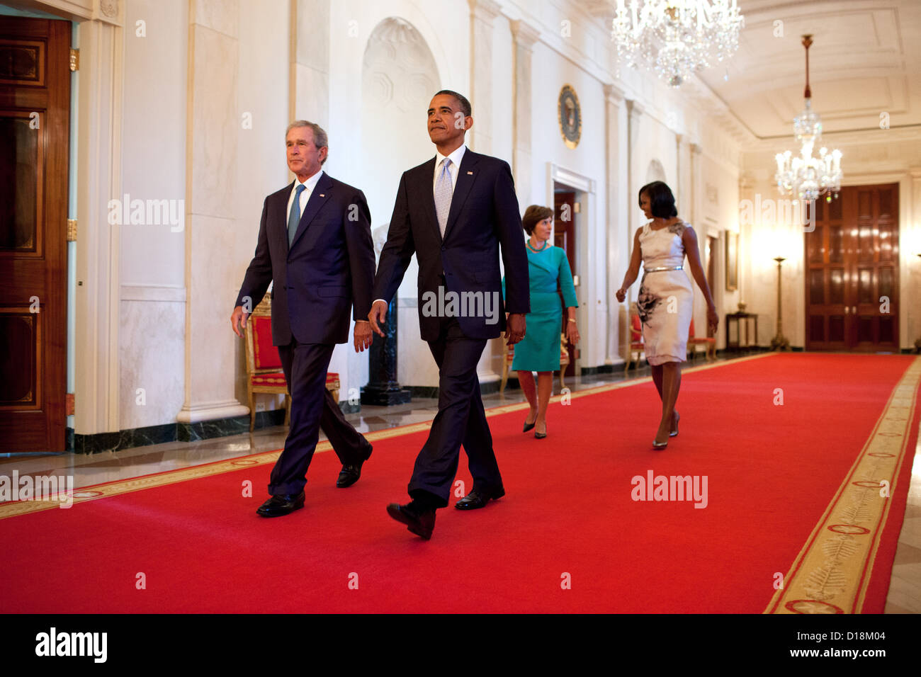 President Barack Obama and First Lady Michelle Obama walk with former President George W. Bush and former First Lady Laura Bush Stock Photo