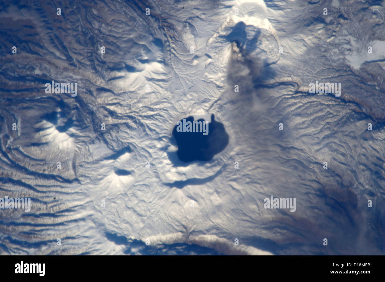 Karymsky stratovolcano on the Kamchatka Peninsula, Russia, after eruption showing plume of ash. Karymsky Lake is to the south. Stock Photo