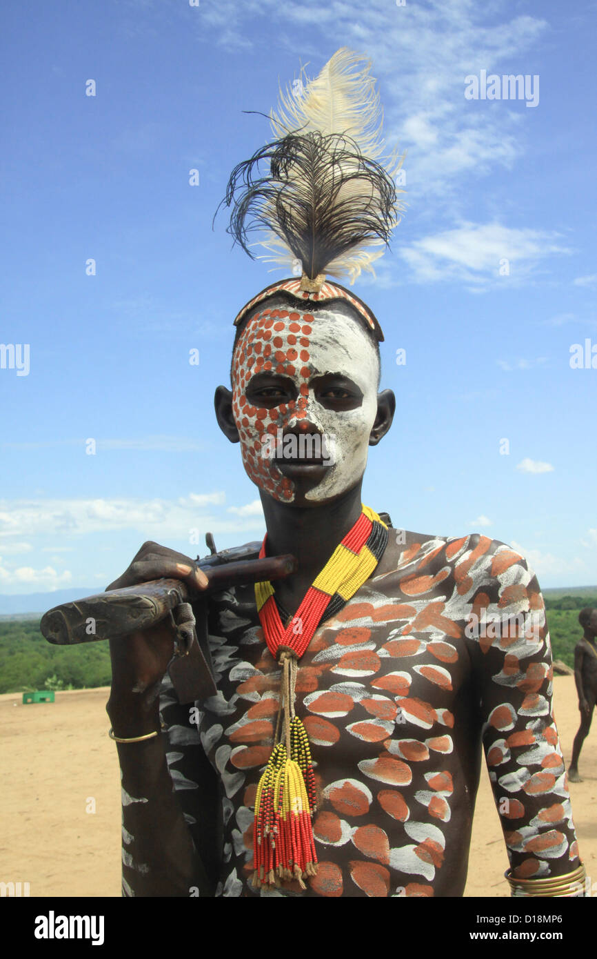 Africa, Ethiopia, Omo Valley, Konso tribe man in front of his thatch roof hut Stock Photo