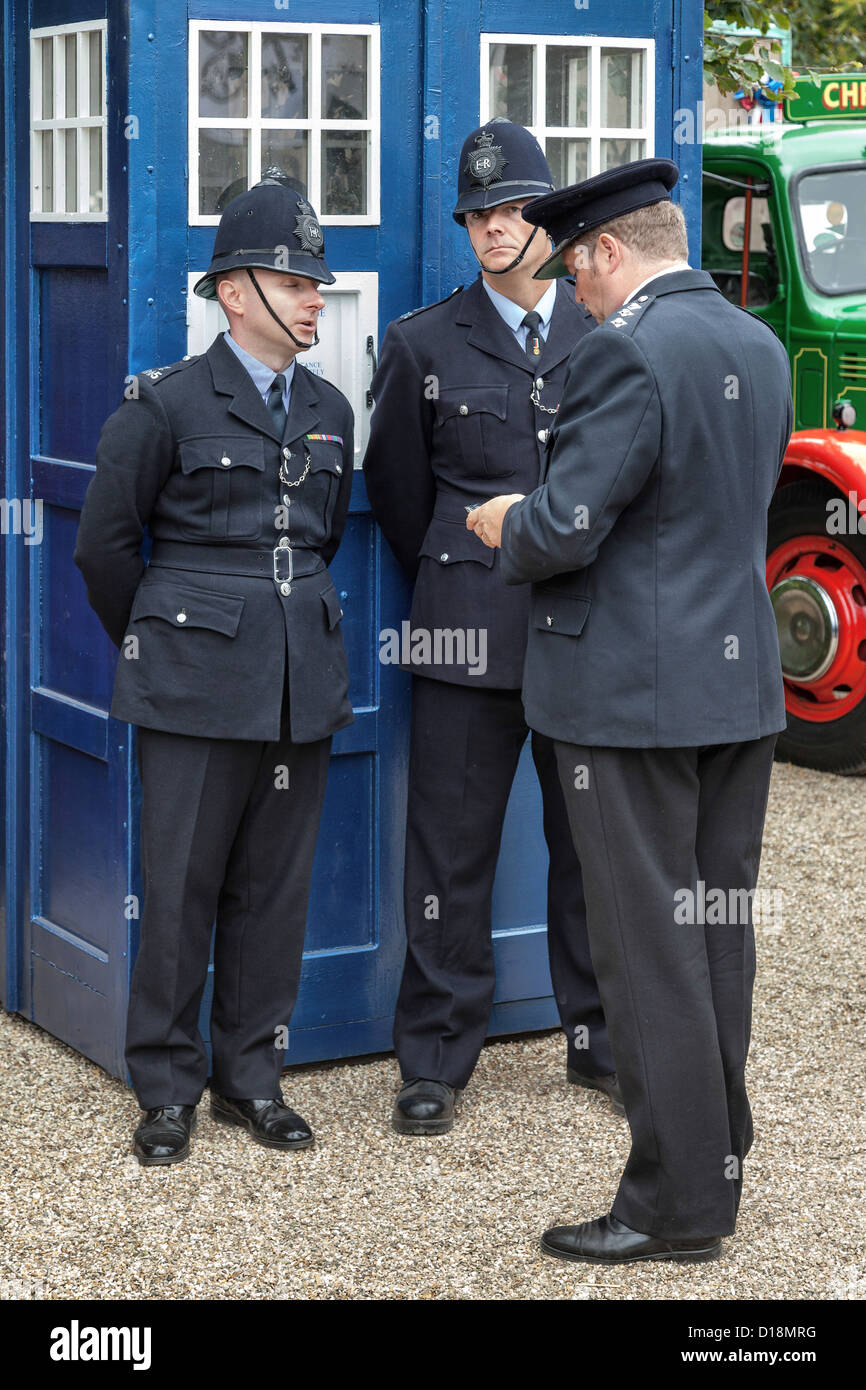 Policemen outside an old fashioned english blue police box Stock Photo