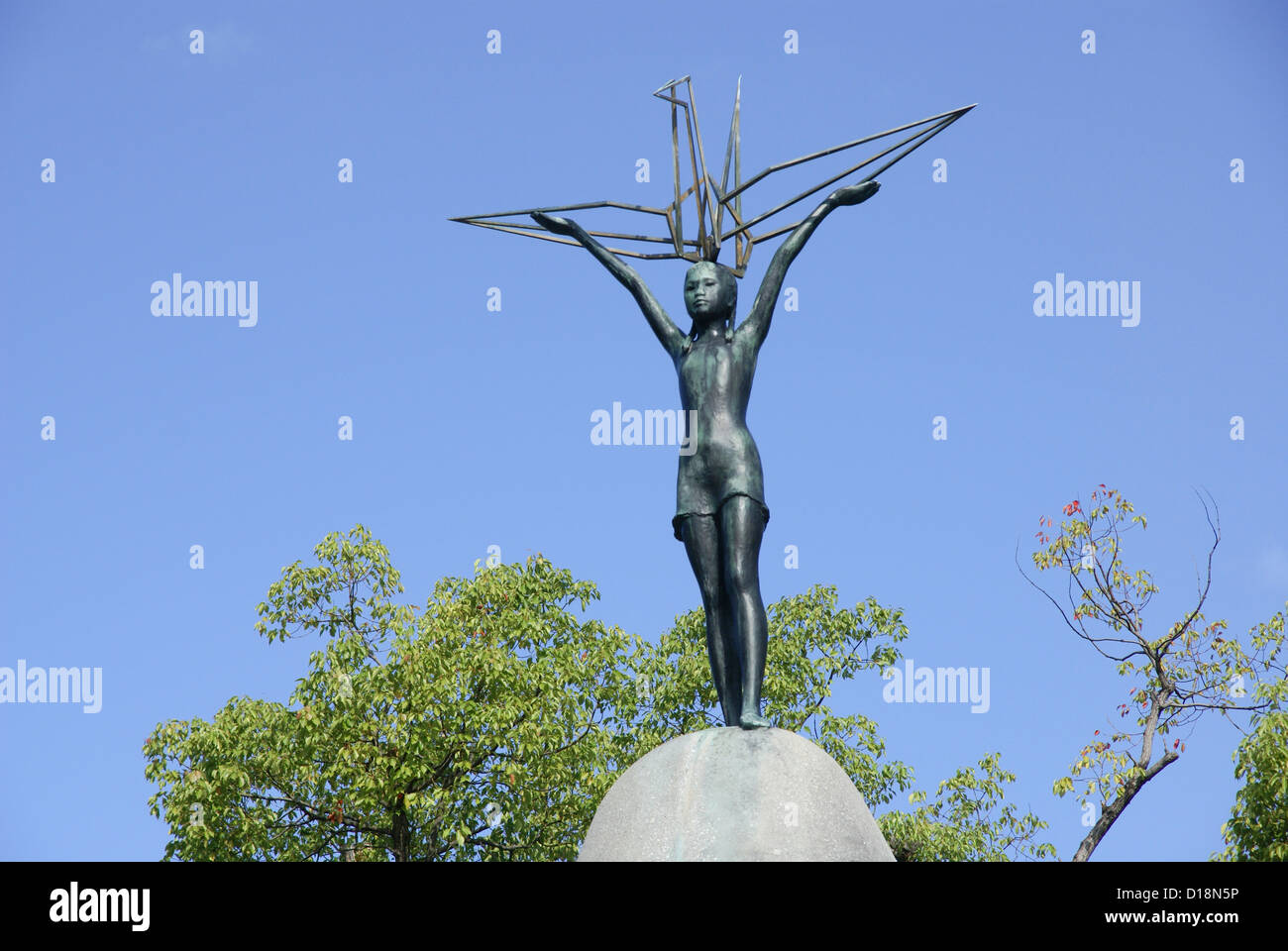 Children's Peace Monument statue of Sasaki Sadako holding a crane. Japan, Honshu, Hiroshima, Stock Photo