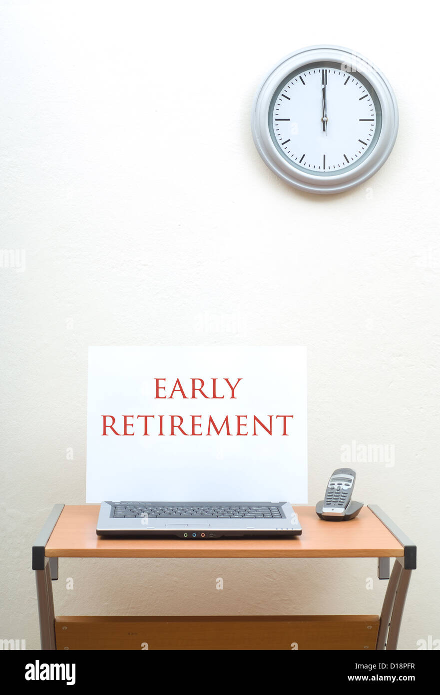 Office Desk With Early Retirement Sign On Open Laptop With