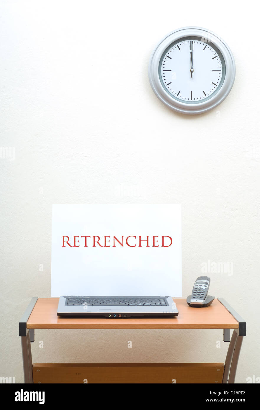 Office Desk With Retrenched Sign On Open Laptop Nest To Phone