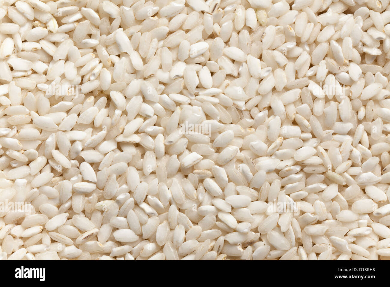the uncooked arborio rice background Stock Photo - Alamy