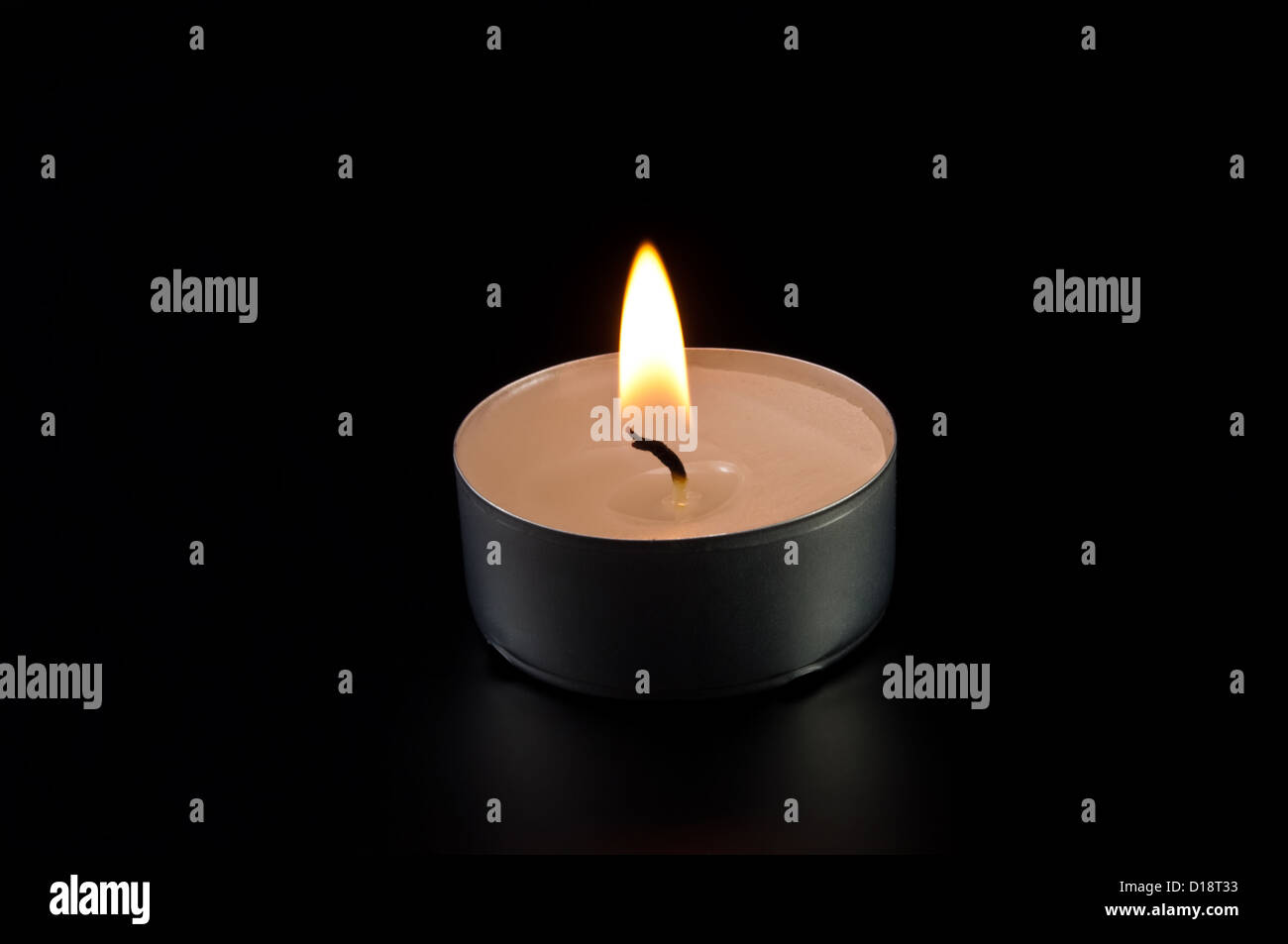 alight candle on black background Stock Photo