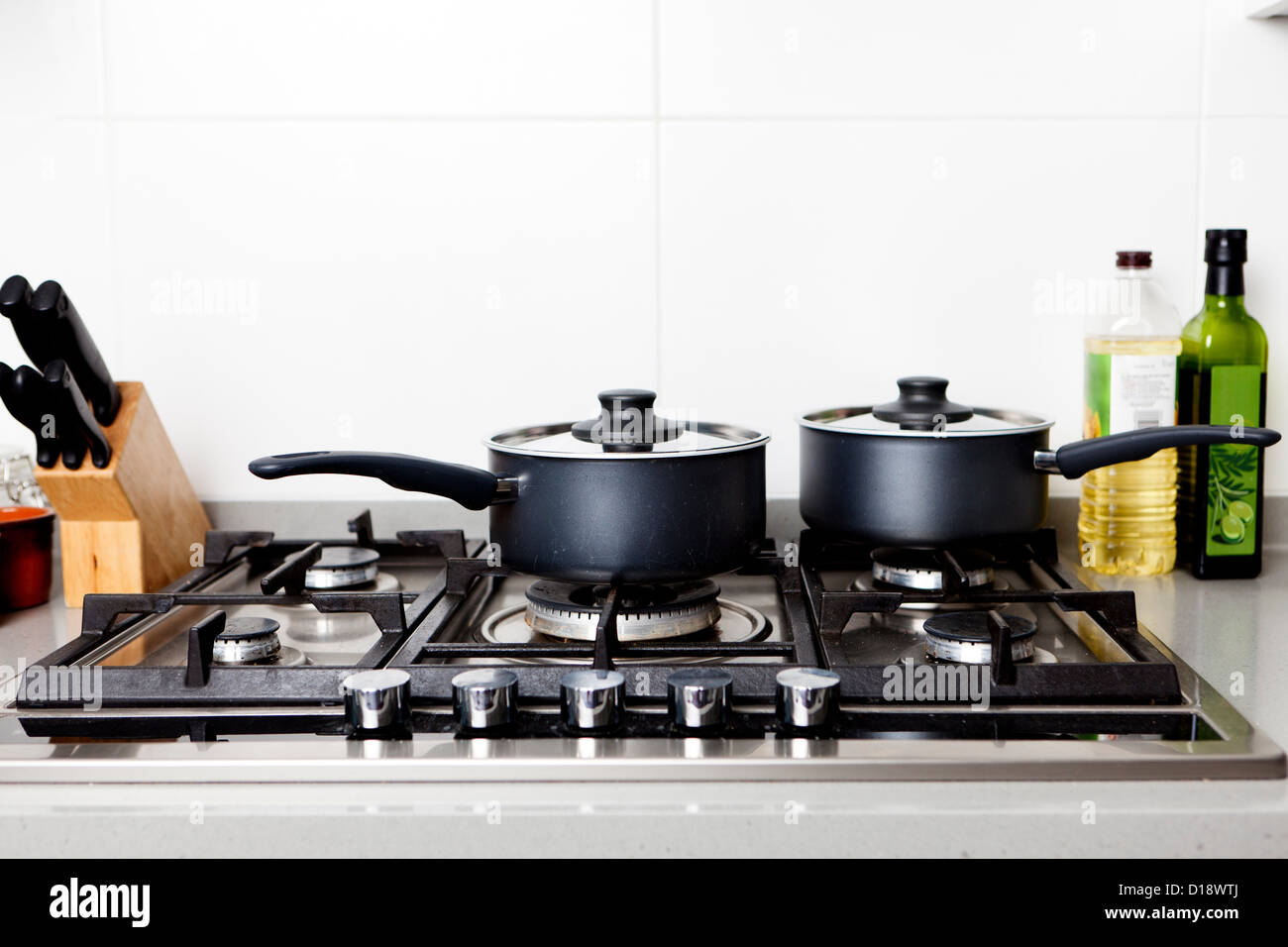 Saucepans on gas hob Stock Photo Alamy