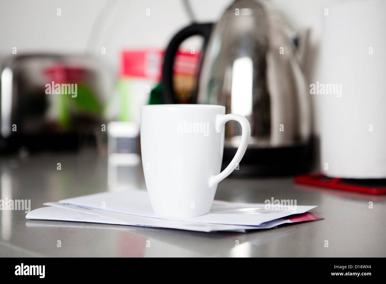 Coffee mug on top of envelopes Stock Photo