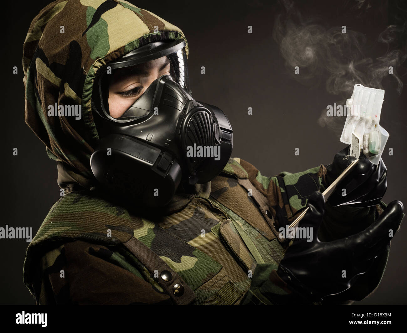 US Marine in MOPP gear inc gas mask uses M272 Chemical Agent Water Testing Kit ( lewisite, nerve agents, cyanide and mustard ) Stock Photo