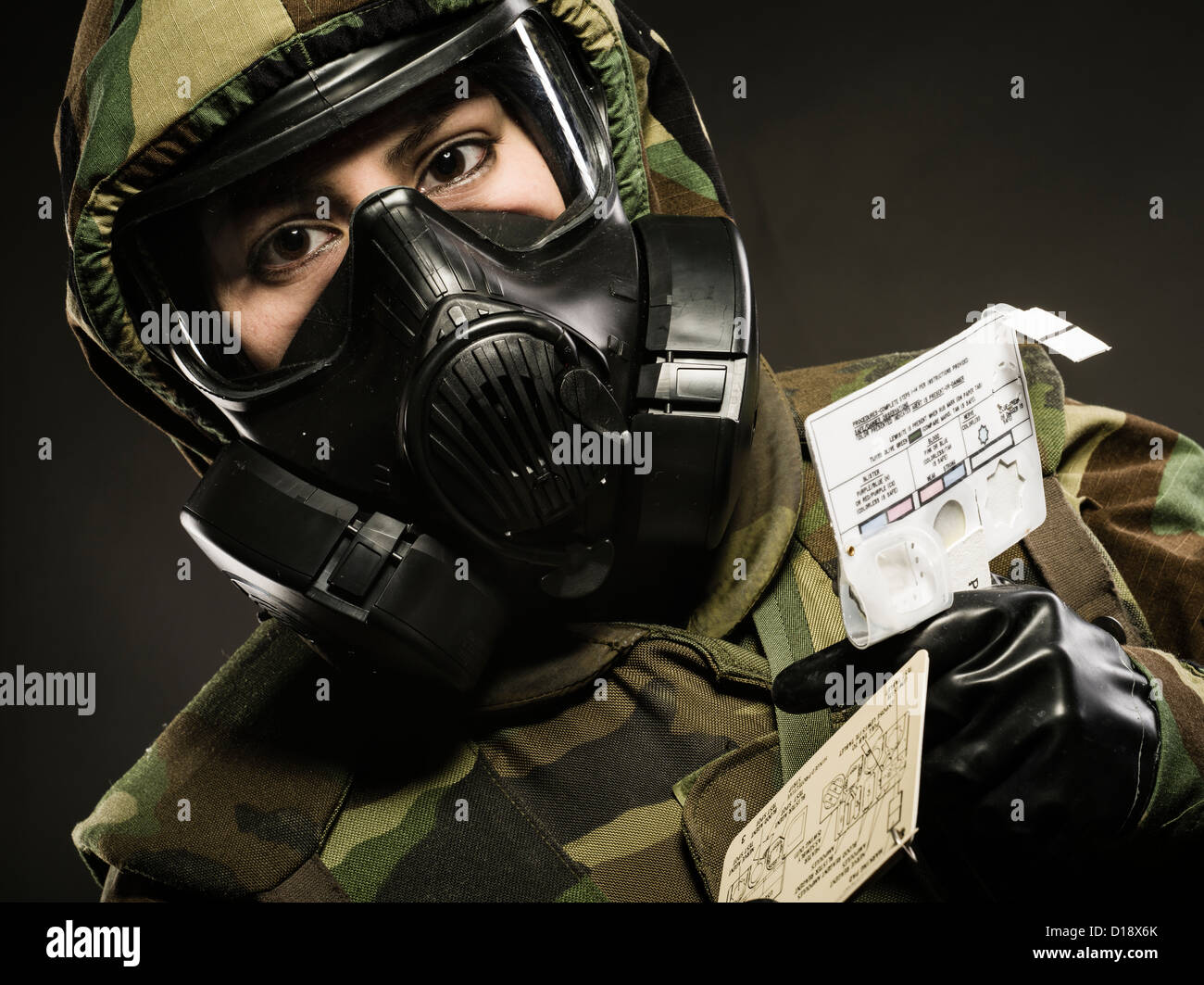 US Marine in MOPP gear inc gas mask uses M272 Chemical Agent Water Testing Kit ( lewisite, nerve agents, cyanide and mustard ) Stock Photo