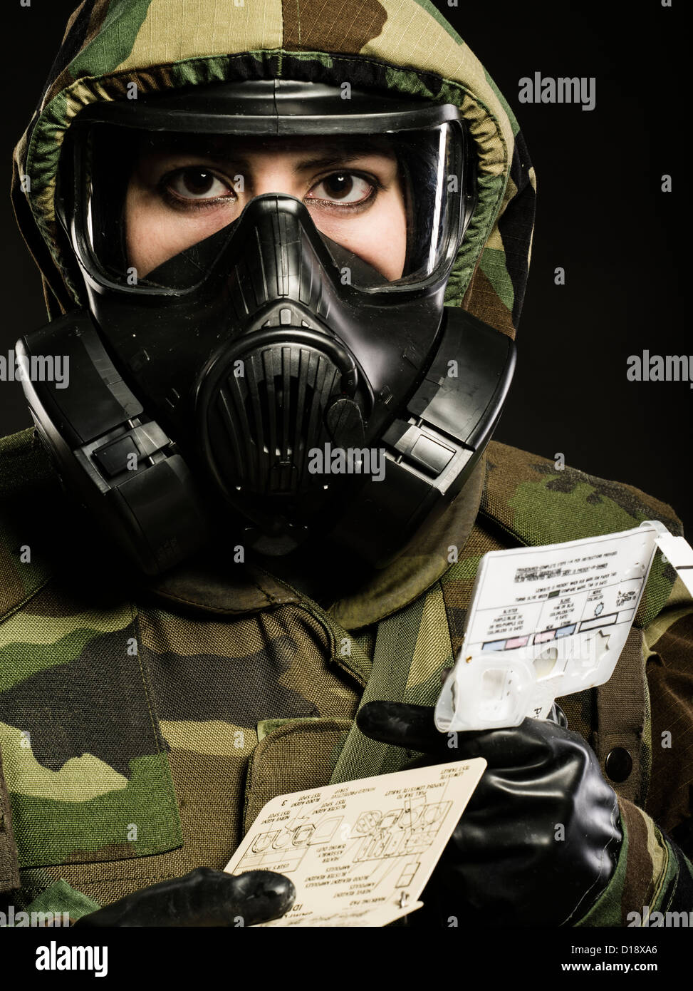 US Marine in MOPP gear inc gas mask uses M272 Chemical Agent Water Testing Kit ( lewisite, nerve agents, cyanide and mustard ) Stock Photo