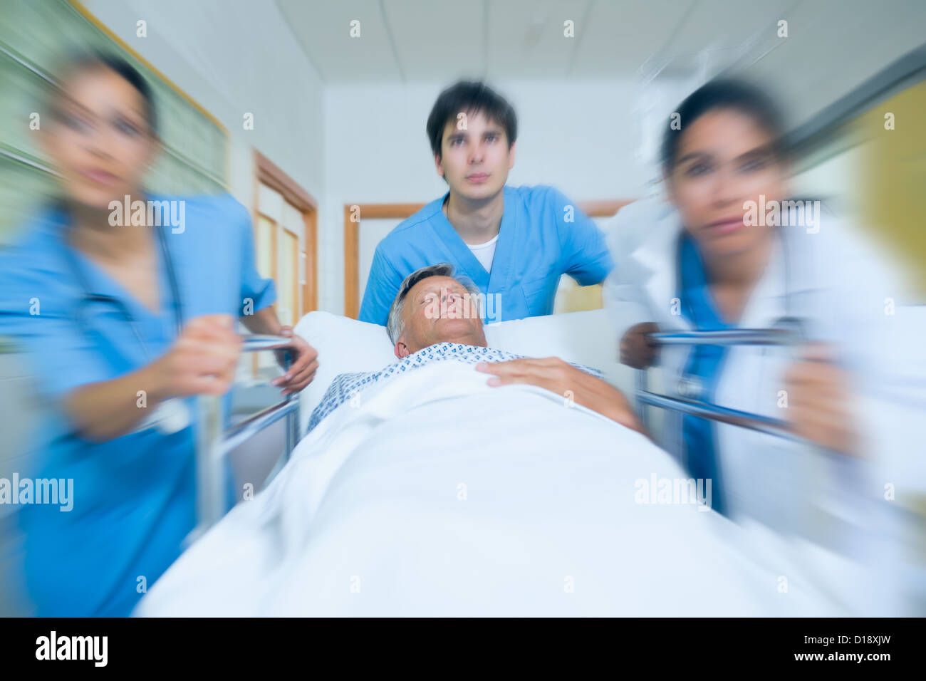 Team of doctor running in a hospital hallway Stock Photo