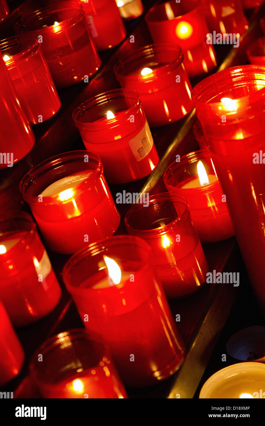 Church candles in red transparent chandeliers Stock Photo