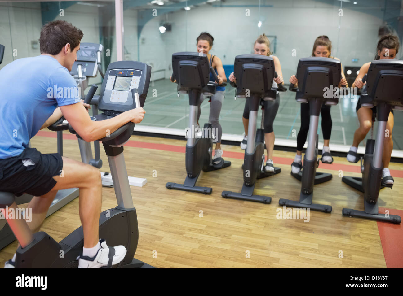 Male instructor teaches spinning class Stock Photo - Alamy