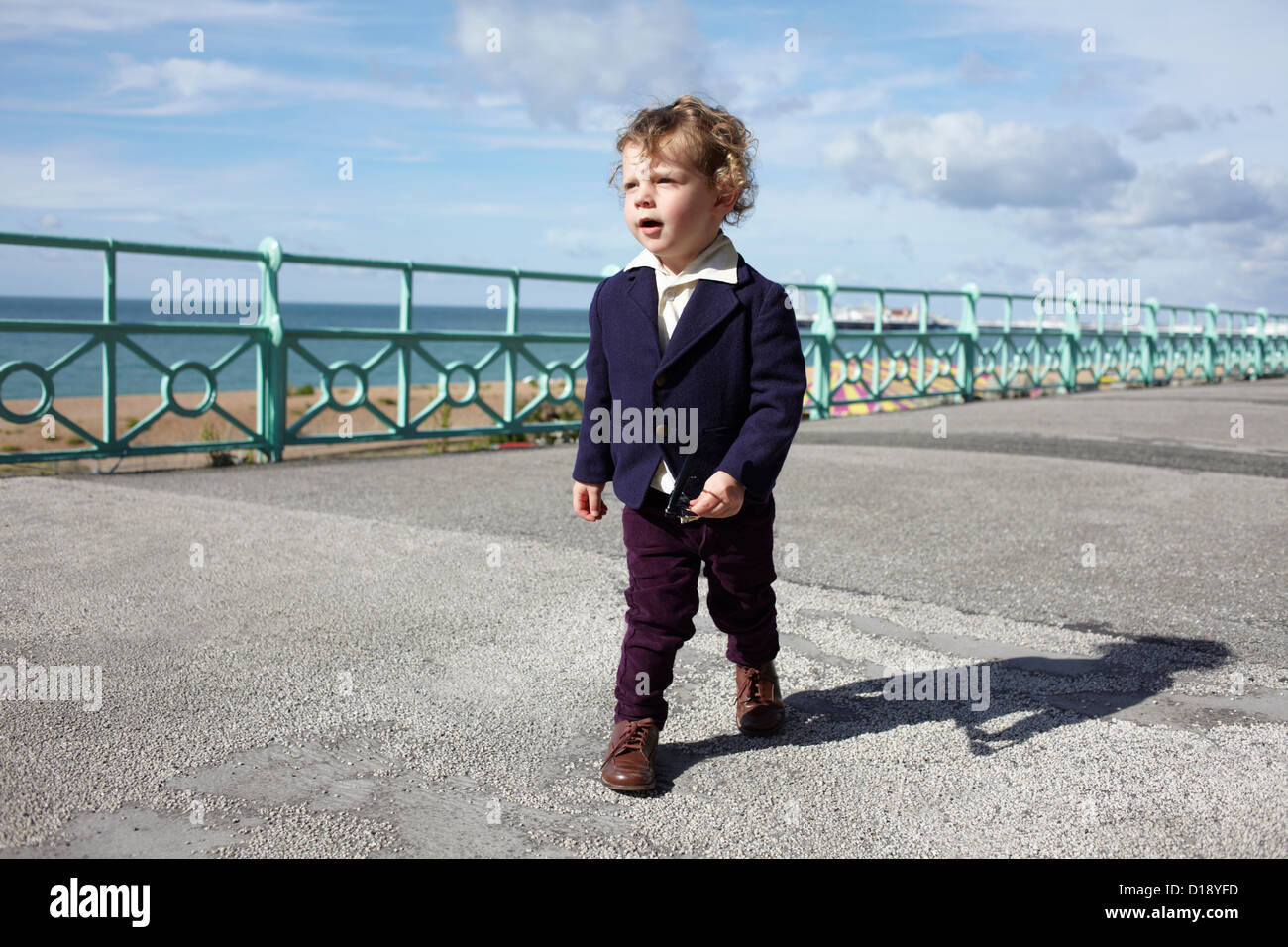 Little boy walking promenade in mod clothing Stock Photo