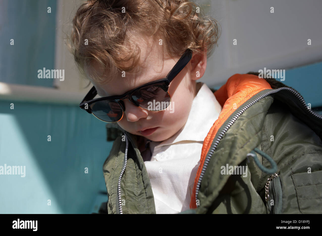 Little boy wearing mod style sunglasses and parka Stock Photo