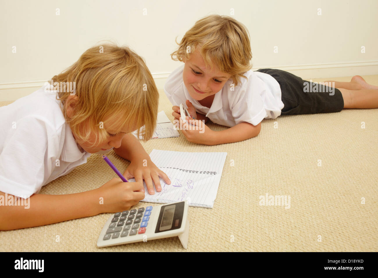 Two schoolboys doing homework Stock Photo - Alamy