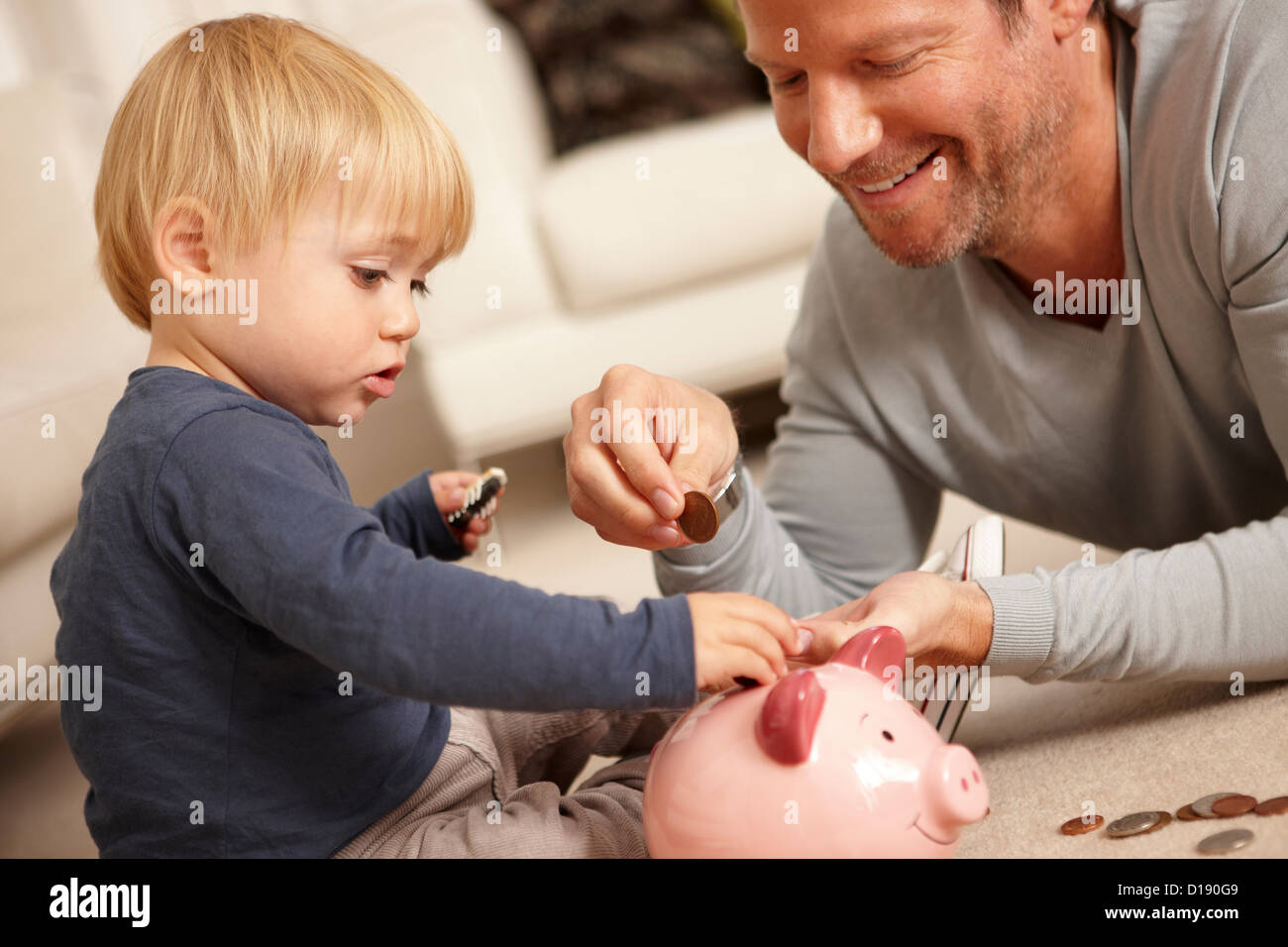 Father and son putting coin piggy bank hi-res stock photography and ...