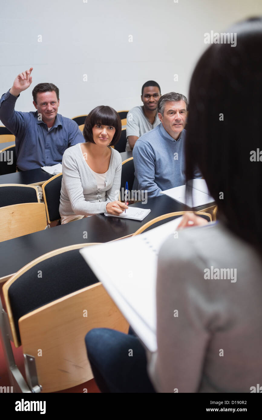 Man asking question in lecture Stock Photo