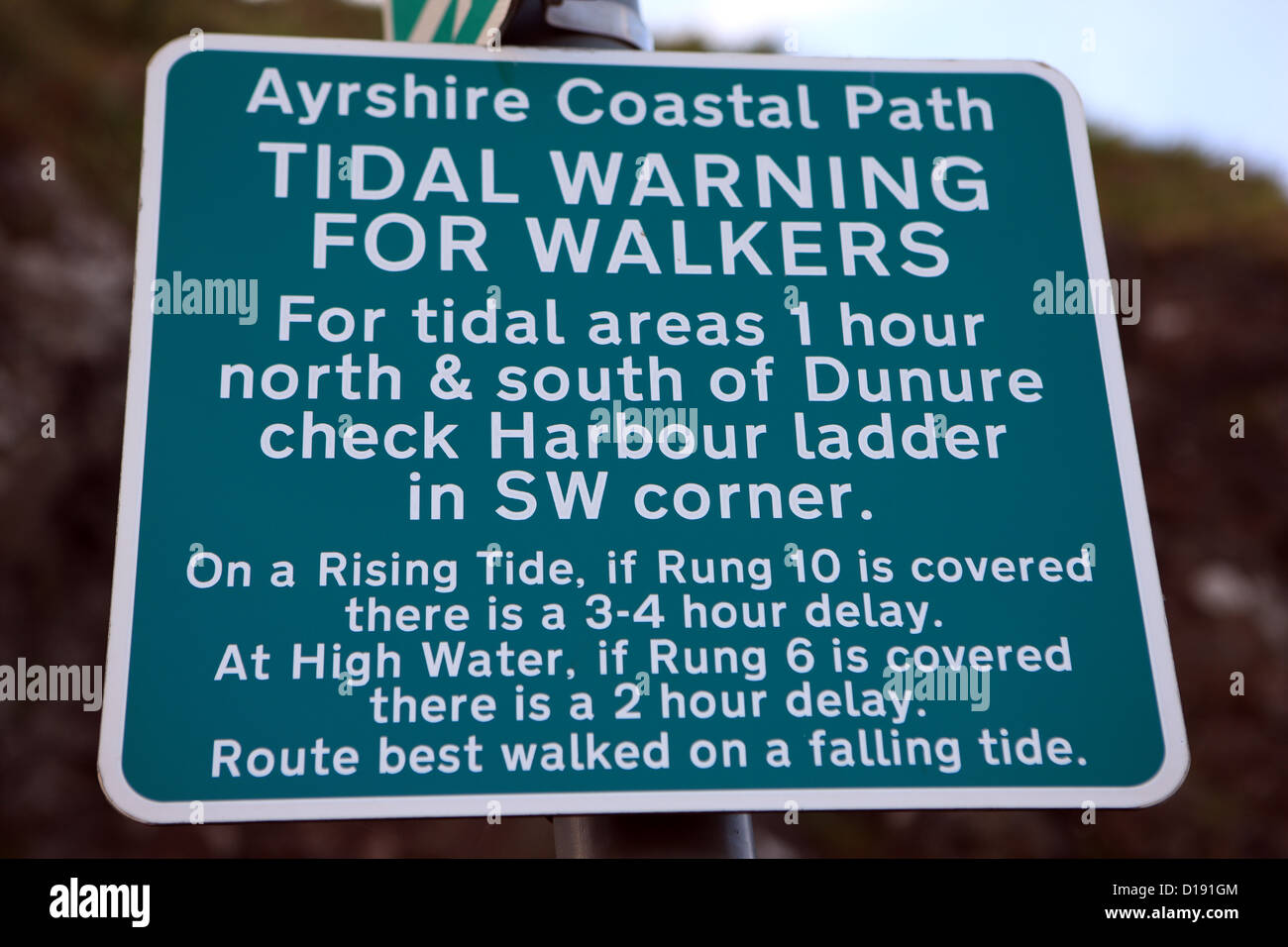 Tidal warning for walkers sign in the Ayrshire coastal town of Dunure Stock Photo