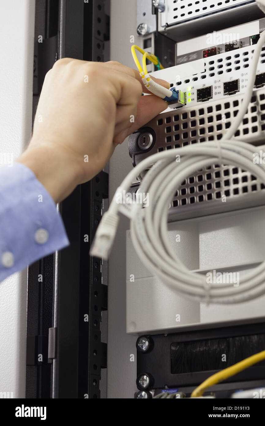 Man inserting USB wire Stock Photo