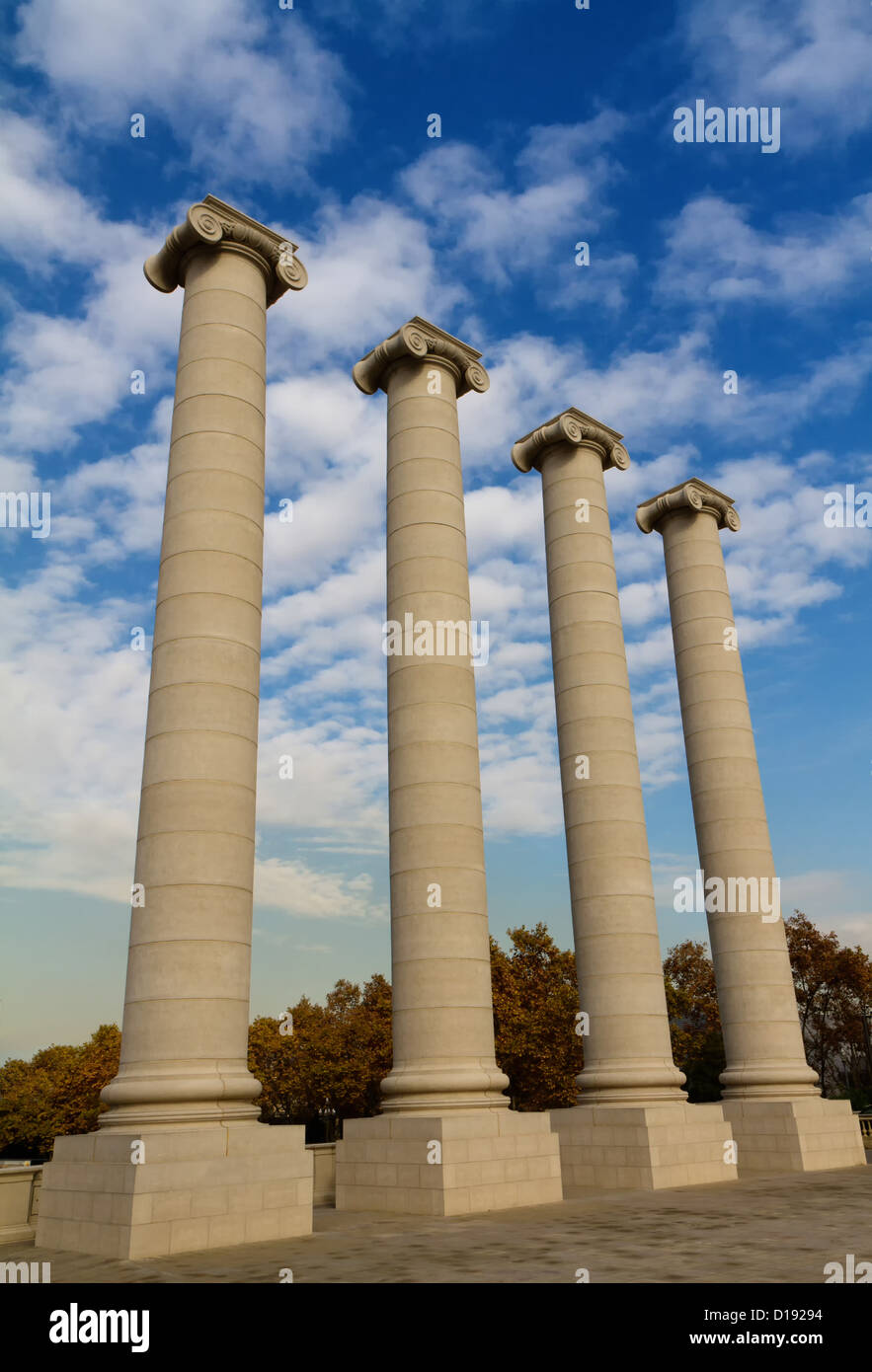 Four massive columns, blue sky Stock Photo