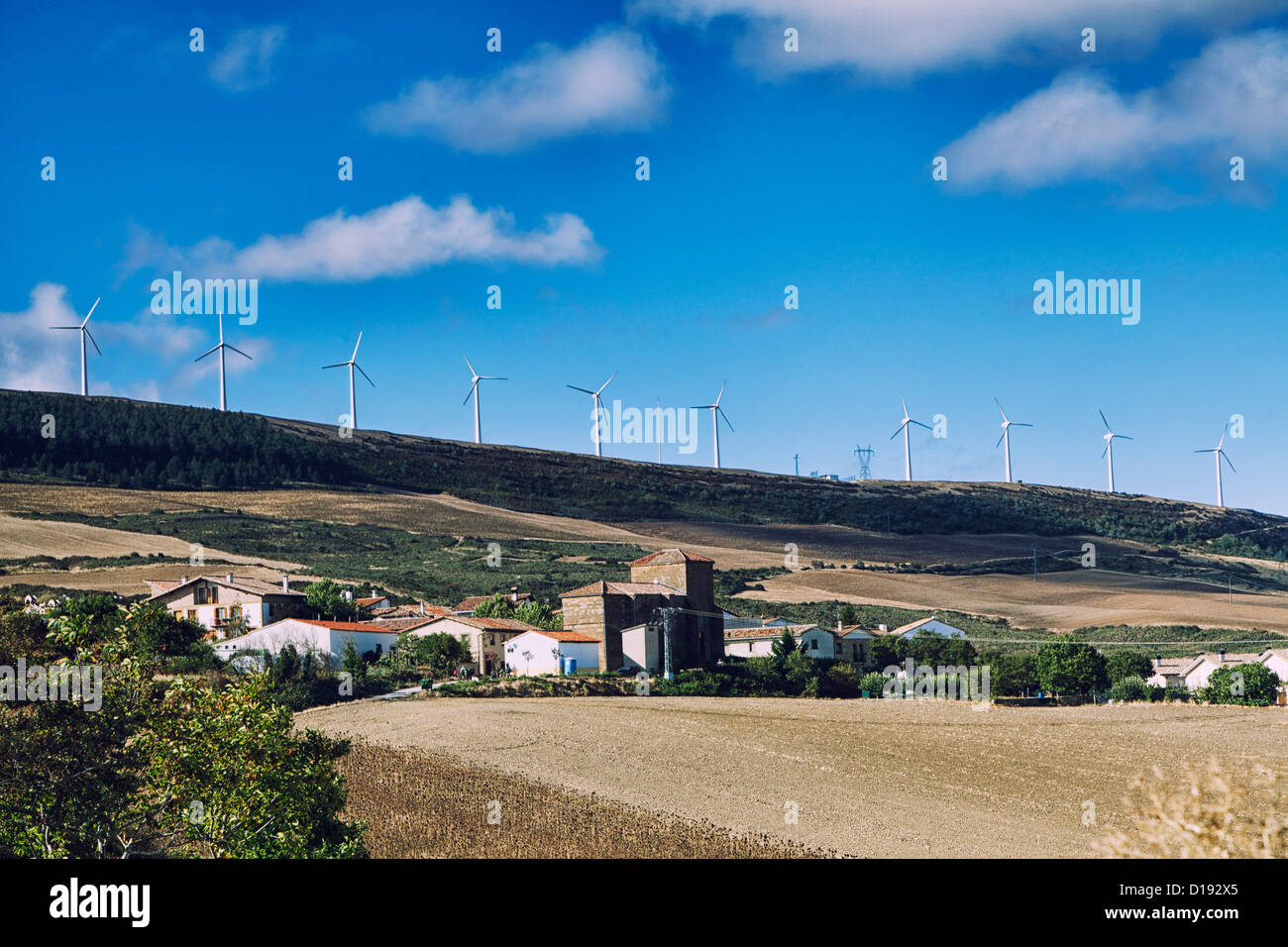 Windmills stand tall along the ridge of Alto de Perdon hear Zarquiegui Spain, the Camino route, near Pamplona Spain. Stock Photo