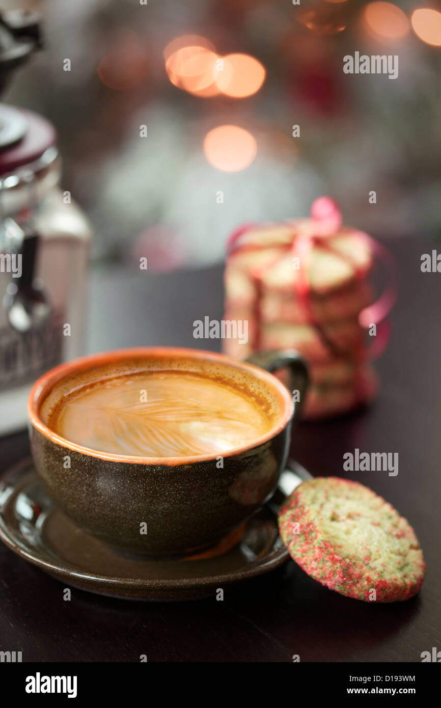 Cappuccino with beautiful latte art and Christmas light bokeh in the background Stock Photo