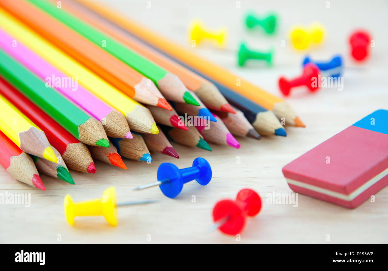 Colored pencils on writing desk Stock Photo Alamy